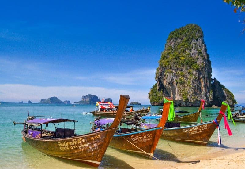 Traditional longtail boats on a tropical beach in Thailand